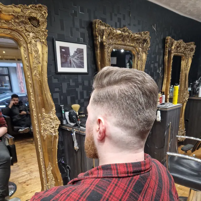 A side-parted cut with a fade, from behind